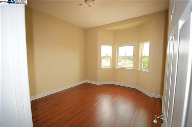 empty room with dark hardwood / wood-style floors