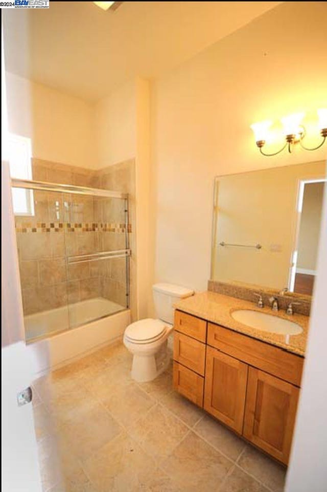 full bathroom with vanity, toilet, combined bath / shower with glass door, and tile patterned flooring