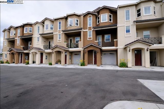 view of property featuring a balcony and a garage