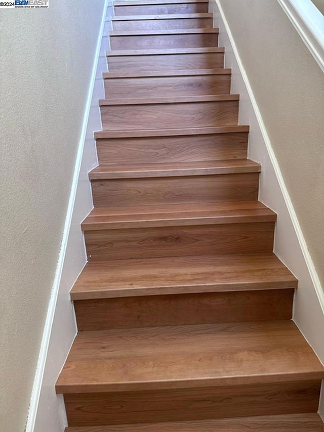 stairway featuring hardwood / wood-style floors