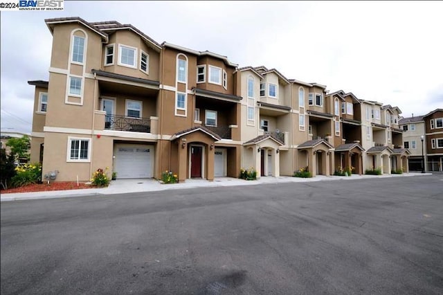 view of front of home featuring a balcony and a garage