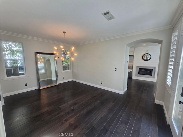 unfurnished dining area with a fireplace, visible vents, dark wood-type flooring, ornamental molding, and baseboards