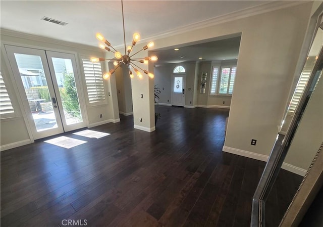 interior space with french doors, visible vents, an inviting chandelier, dark wood-type flooring, and ornamental molding