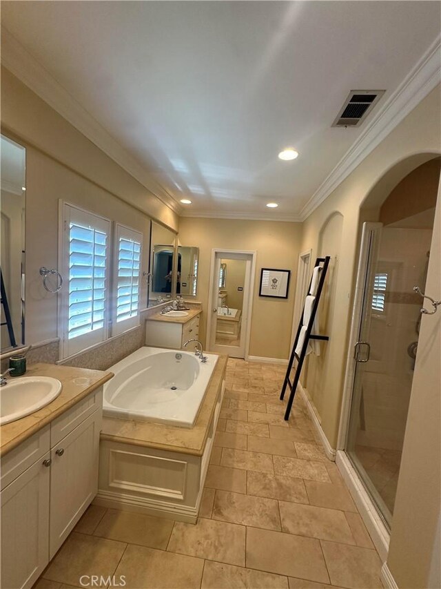 bathroom with vanity, an enclosed shower, and ornamental molding