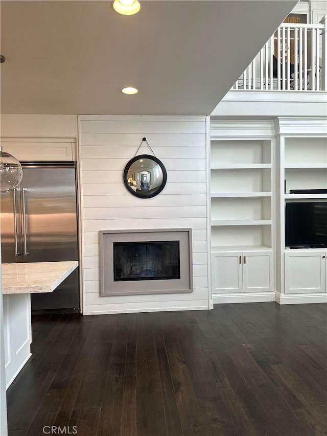 unfurnished living room with dark hardwood / wood-style flooring