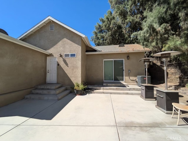 back of property with a patio area and central AC unit