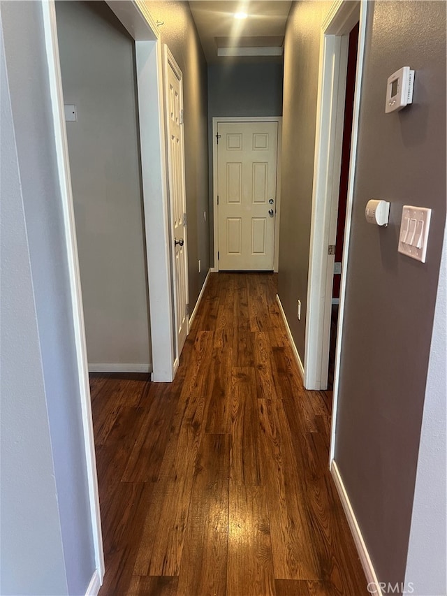 corridor featuring dark hardwood / wood-style floors