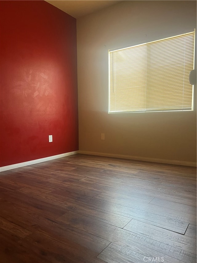 unfurnished room featuring hardwood / wood-style flooring