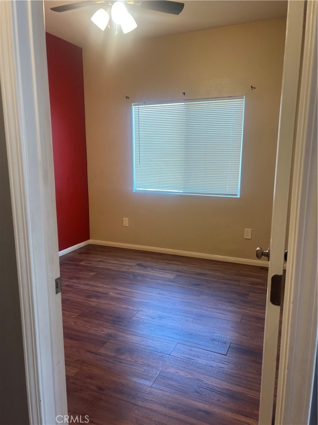 unfurnished room with ceiling fan and dark hardwood / wood-style floors