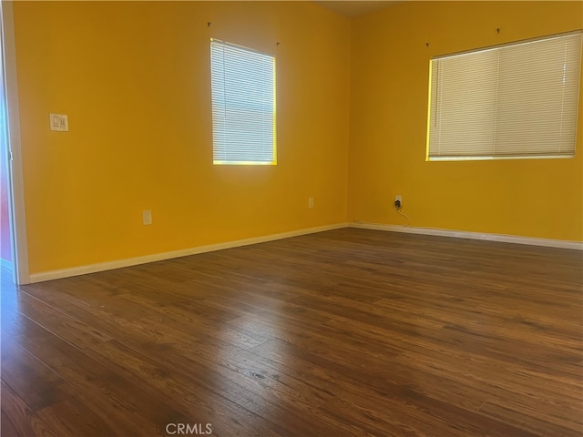 unfurnished room featuring dark hardwood / wood-style flooring