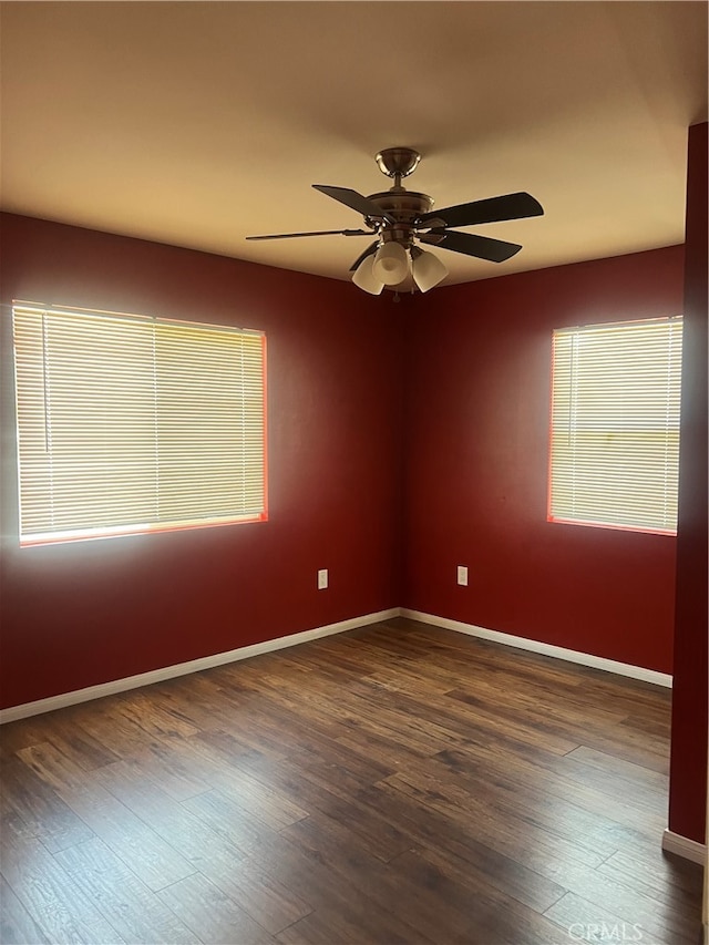 spare room featuring dark hardwood / wood-style floors and ceiling fan