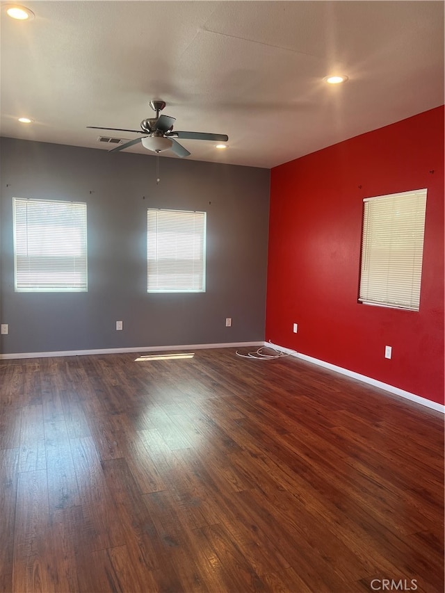 spare room featuring ceiling fan and dark hardwood / wood-style flooring