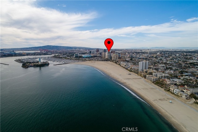 drone / aerial view with a water view and a beach view