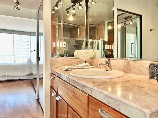 bathroom featuring vanity, hardwood / wood-style floors, and a shower with shower door