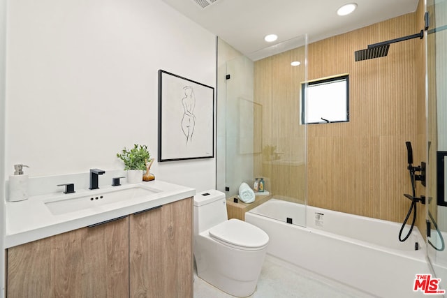 full bathroom with shower / bath combination with glass door, vanity, and toilet