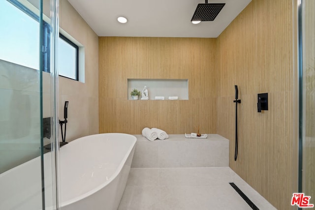 bathroom featuring wooden walls, tile patterned flooring, and plus walk in shower