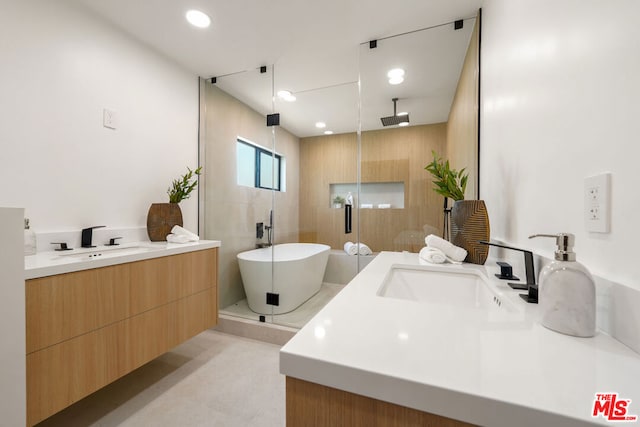 bathroom featuring vanity and shower with separate bathtub