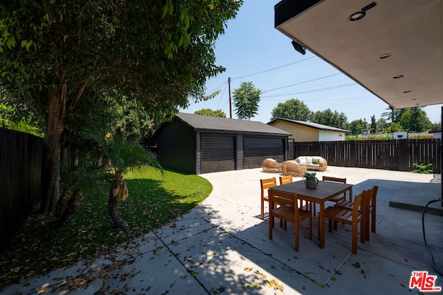 view of patio / terrace featuring a garage and an outdoor structure