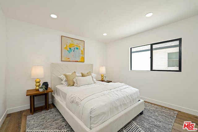 bedroom with hardwood / wood-style flooring