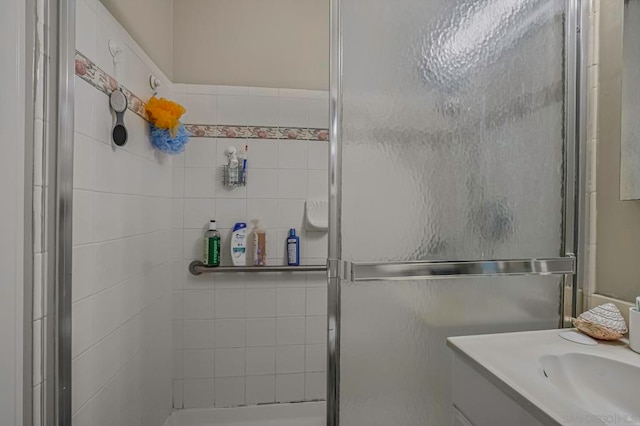 bathroom with vanity and a shower with shower door