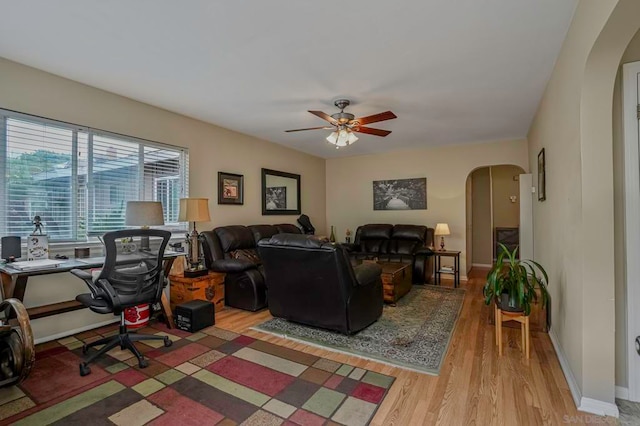 living room featuring light hardwood / wood-style floors and ceiling fan