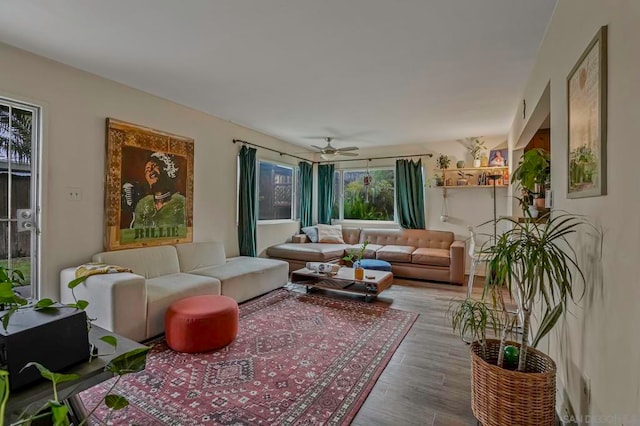 living room with hardwood / wood-style flooring and ceiling fan