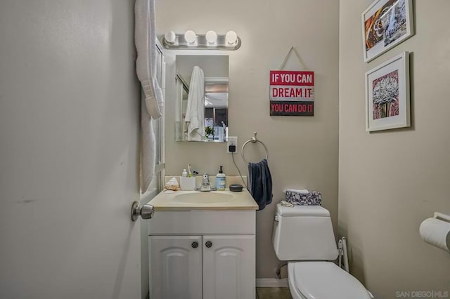 bathroom featuring toilet and vanity