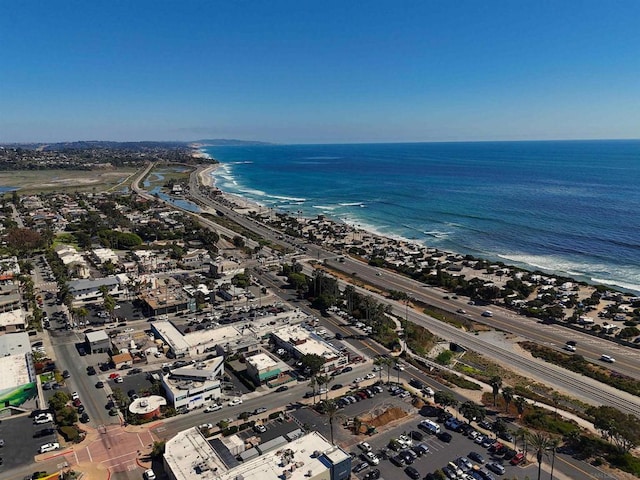 birds eye view of property with a water view and a view of the beach