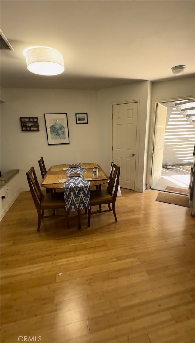 dining area featuring light wood-type flooring