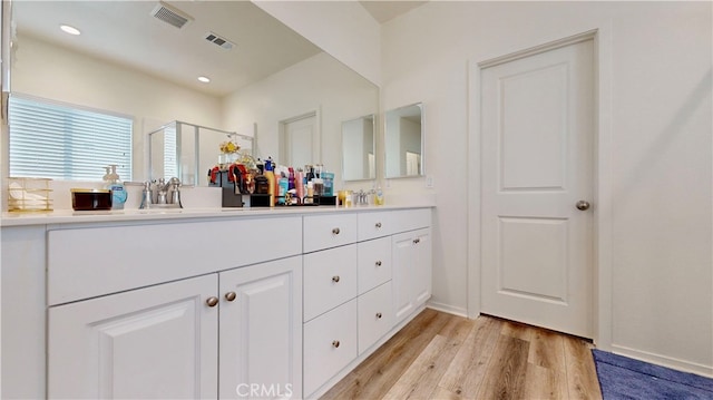 bathroom with vanity, hardwood / wood-style floors, and an enclosed shower