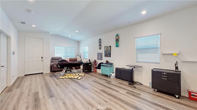 interior space featuring lofted ceiling and light hardwood / wood-style flooring