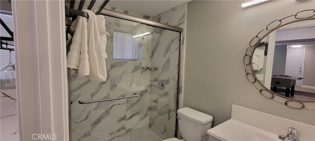 bathroom with toilet, an enclosed shower, and vanity