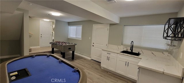 playroom featuring sink and light hardwood / wood-style flooring