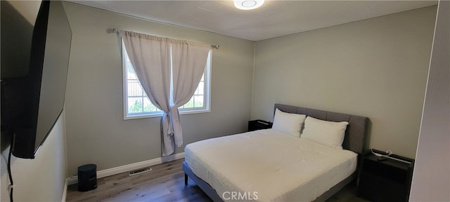 bedroom with hardwood / wood-style flooring