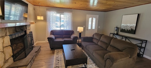 living room with wood ceiling, a fireplace, and light wood-type flooring