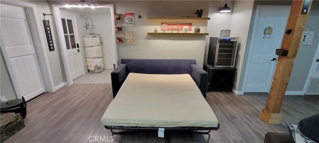 interior space with gas water heater and hardwood / wood-style floors