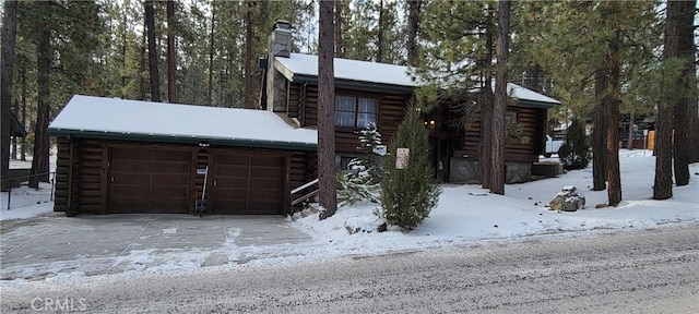 log home featuring a garage