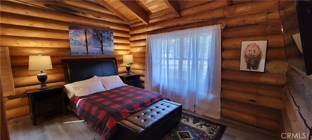 bedroom with vaulted ceiling with beams, rustic walls, hardwood / wood-style flooring, and wood ceiling