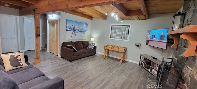 living room featuring beam ceiling, wood ceiling, and hardwood / wood-style floors