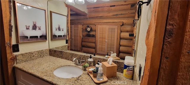 bathroom with vanity and rustic walls