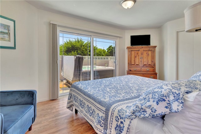 bedroom featuring light hardwood / wood-style floors and access to outside