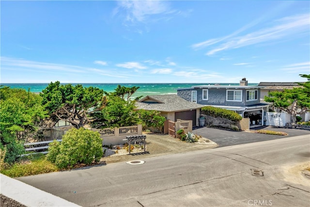 view of front of house featuring a water view and a garage