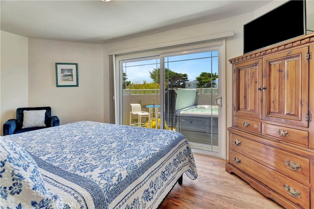 bedroom with light hardwood / wood-style floors and access to outside