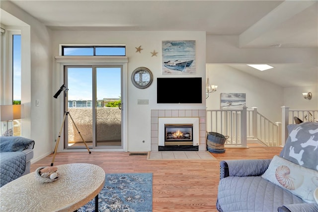 living room featuring hardwood / wood-style floors and a tile fireplace