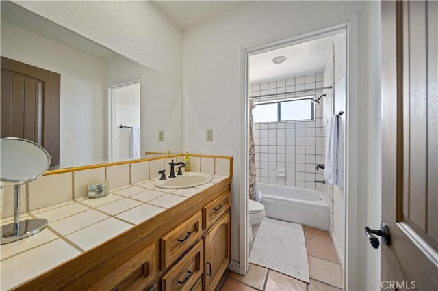 full bathroom featuring tile patterned floors, vanity, shower / bath combination with curtain, and toilet