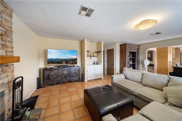 living room featuring a fireplace and light tile patterned floors