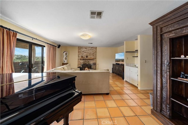 kitchen featuring light tile patterned floors and a fireplace