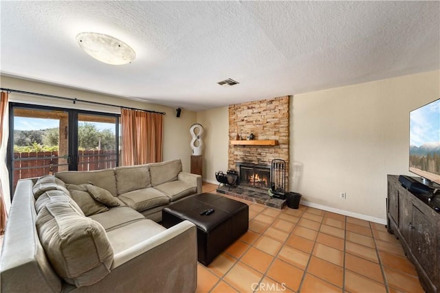 living room featuring a stone fireplace, light tile patterned floors, a textured ceiling, and french doors