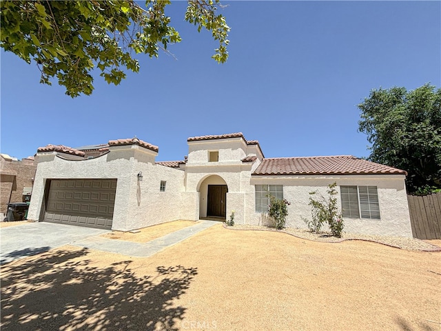 mediterranean / spanish home with a garage