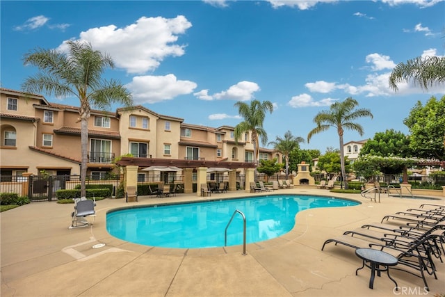 view of pool featuring a fireplace and a patio area